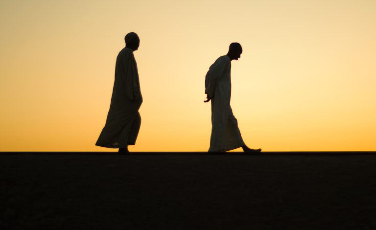 Two men walking in the sunset Sudan